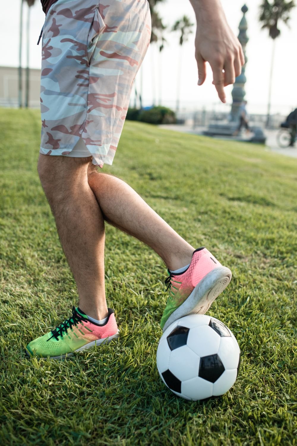 Football player kicking a ball on the pitch